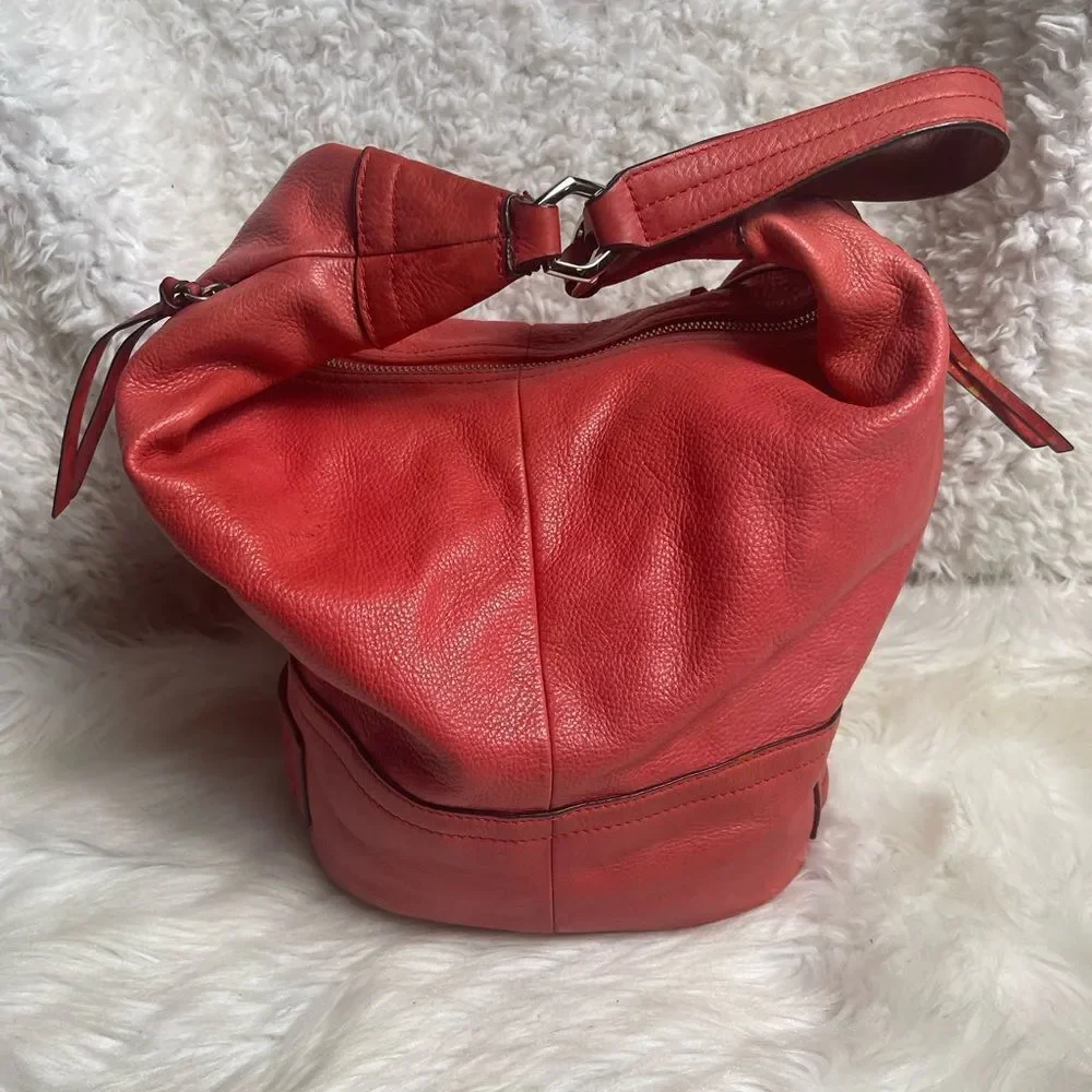 B Makowsky leather orange Hobo bucket style shoulder bag  silver tone hardwares